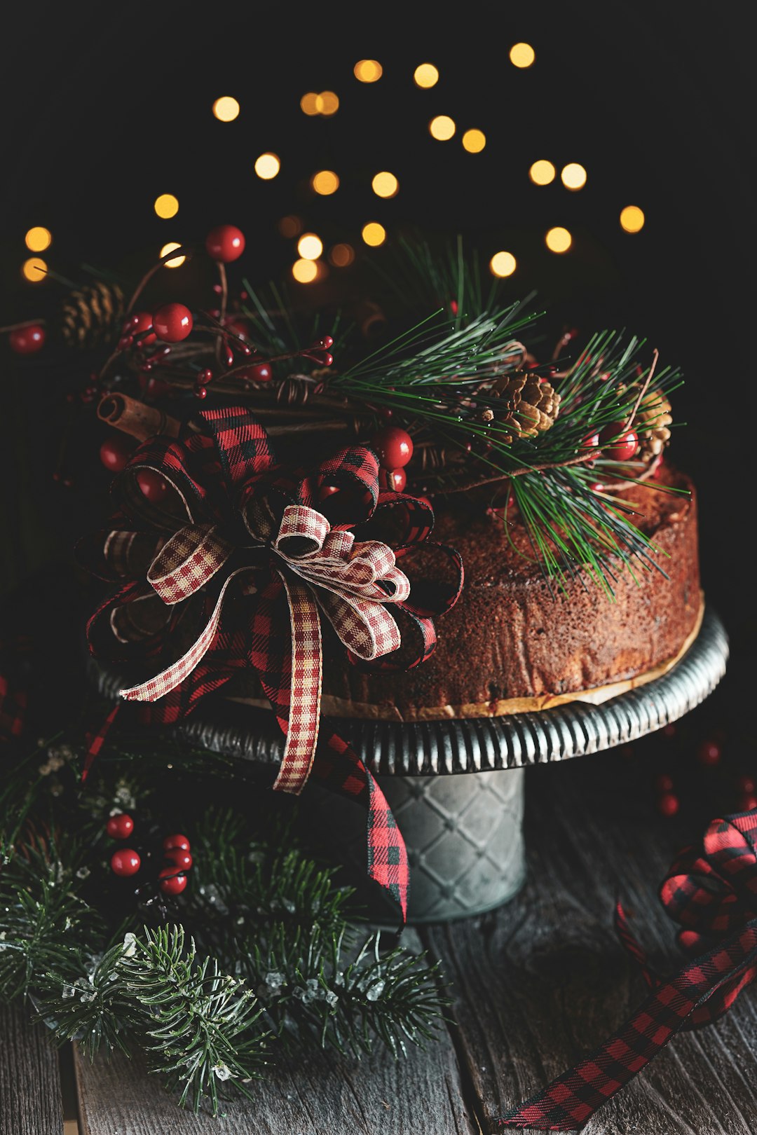 brown and white cake with red and white ribbon on brown wooden table