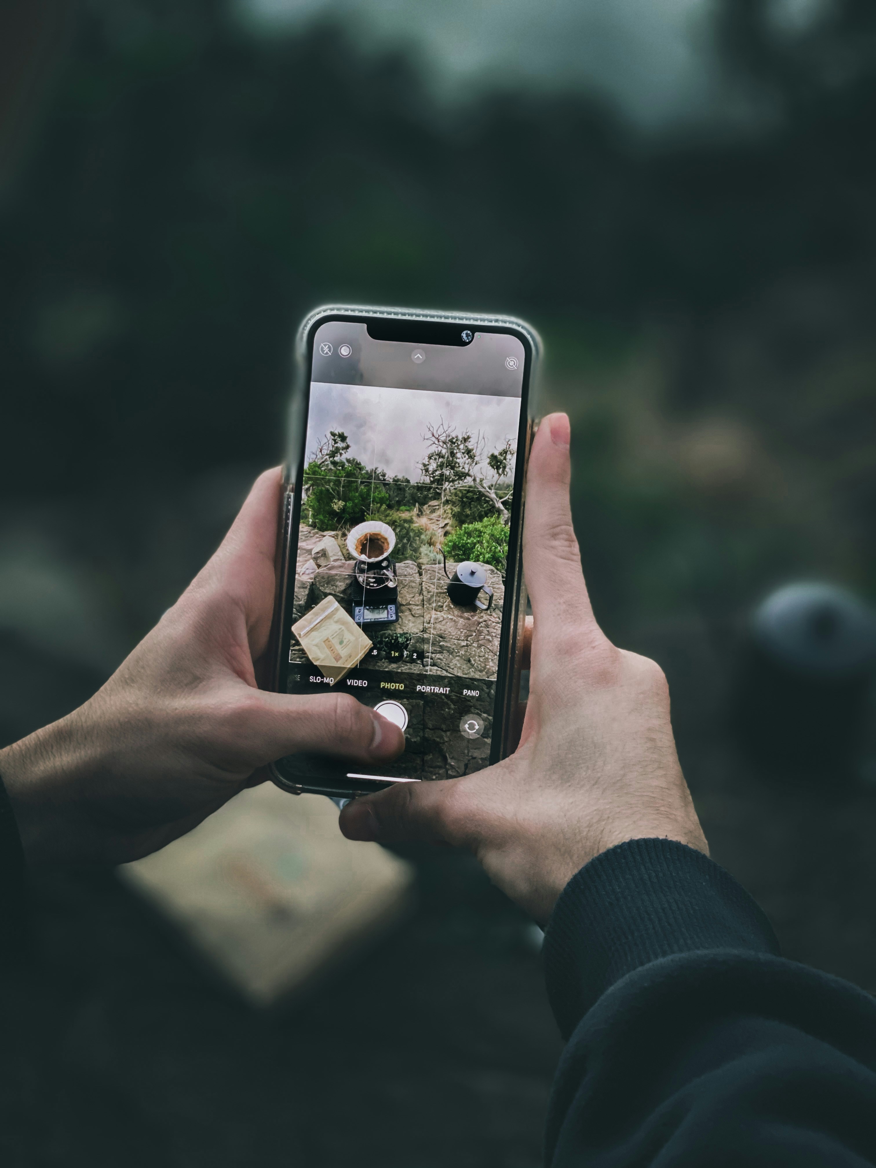person holding silver iphone 6 with black case