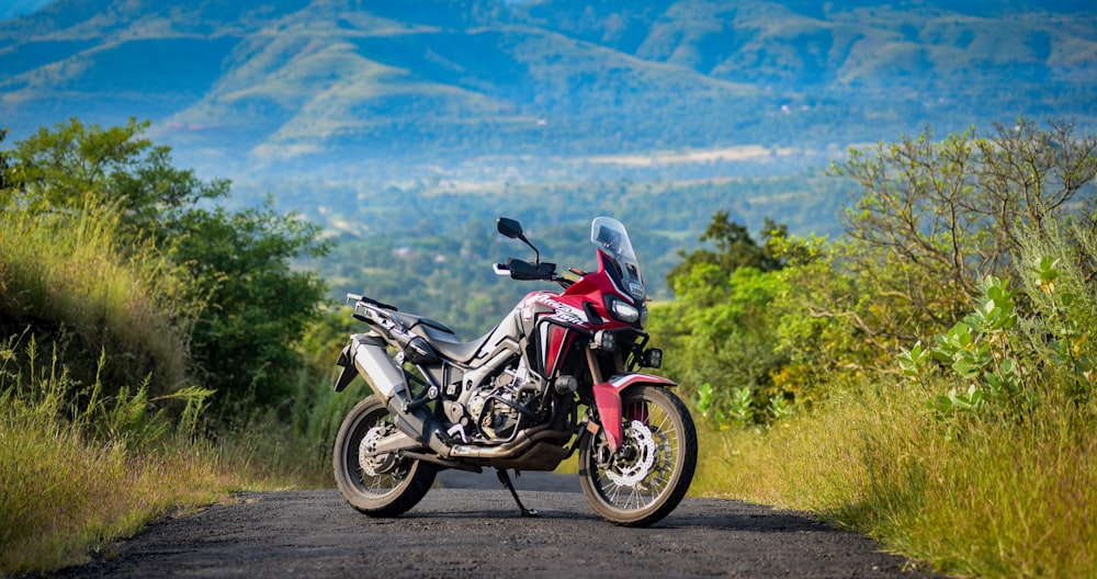 black and red sports bike on dirt road during daytime