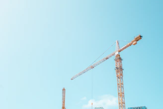 orange crane under white sky