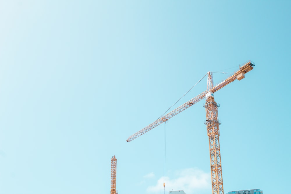 orange crane under white sky