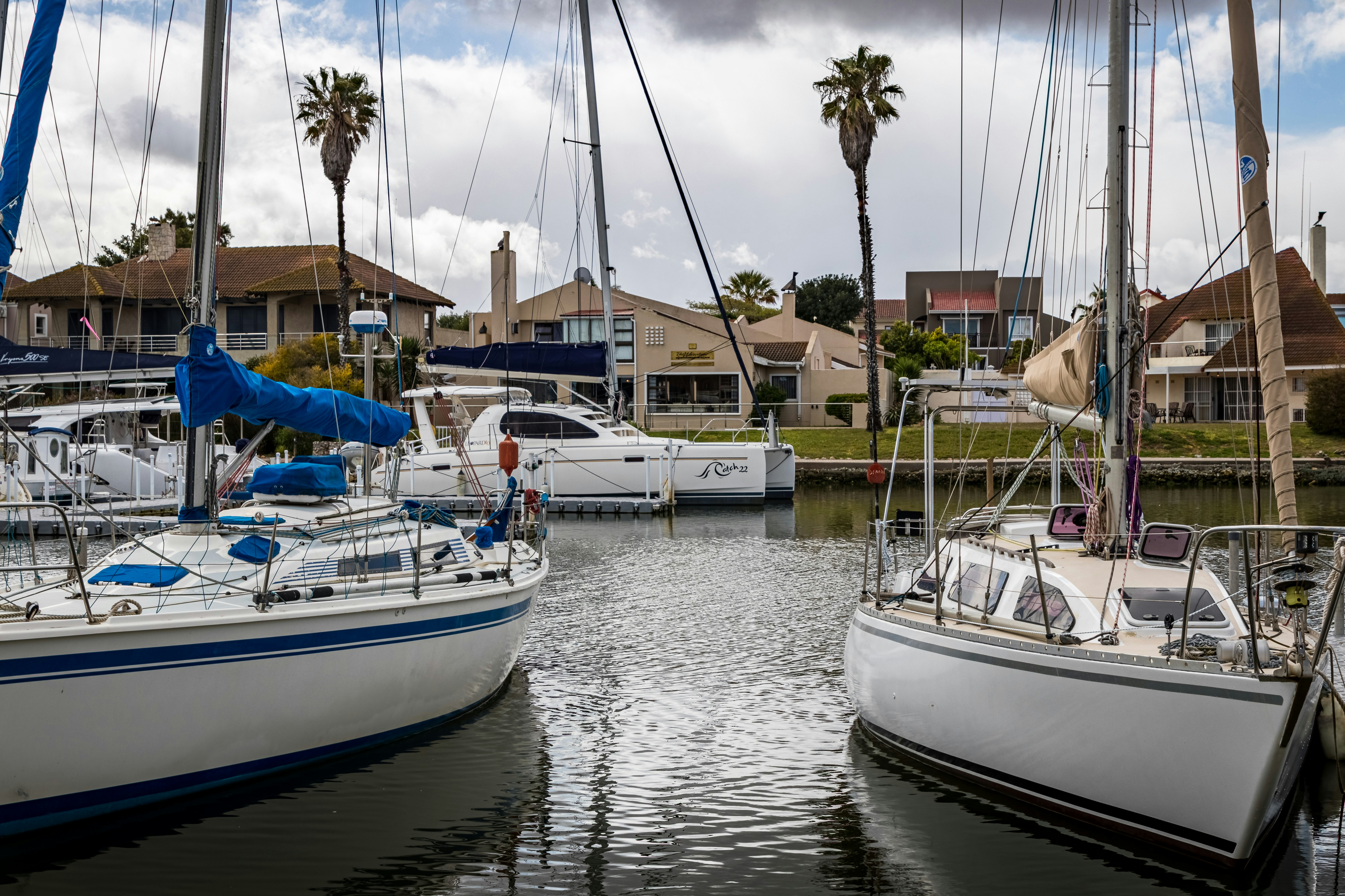 white and blue boat on body of water during daytime