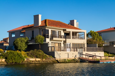 white and brown concrete building beside river during daytime