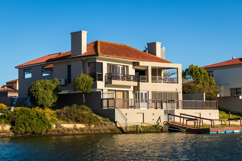 white and brown concrete building beside river during daytime