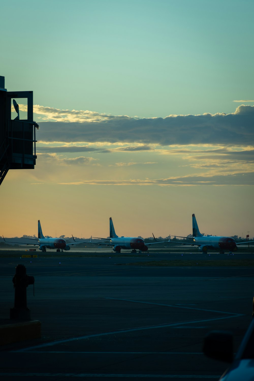 white passenger plane on airport during sunset