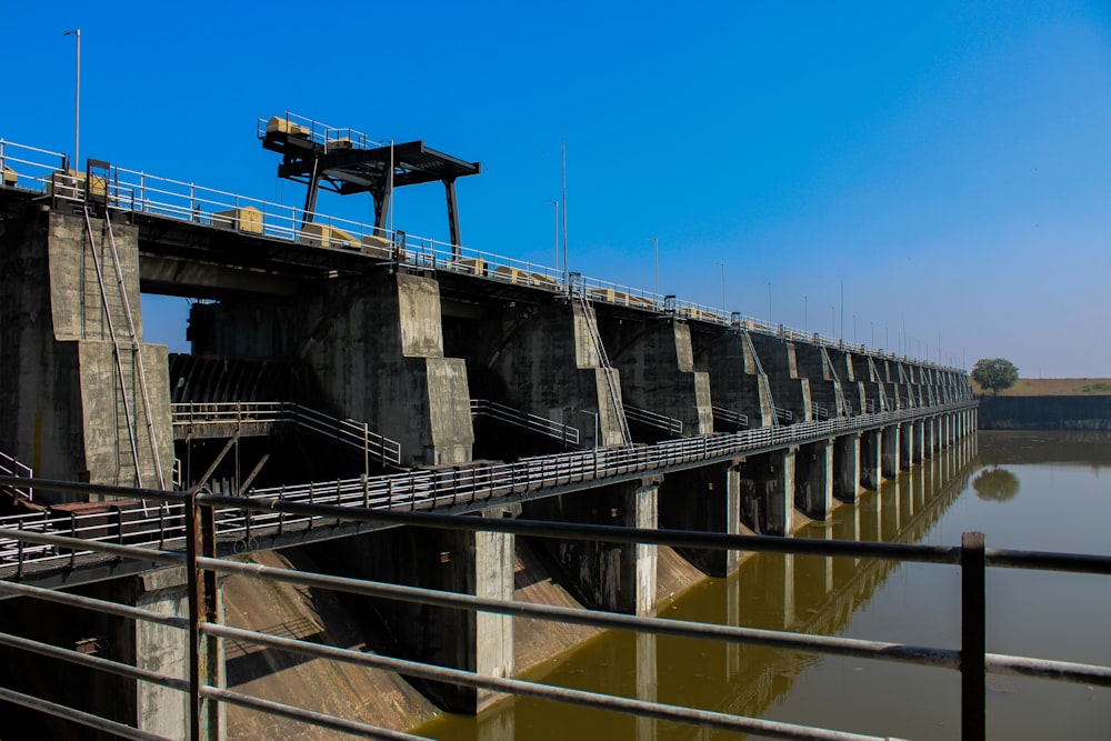 black and gray metal bridge under blue sky during daytime