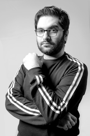 man in black and white striped long sleeve shirt wearing black framed eyeglasses