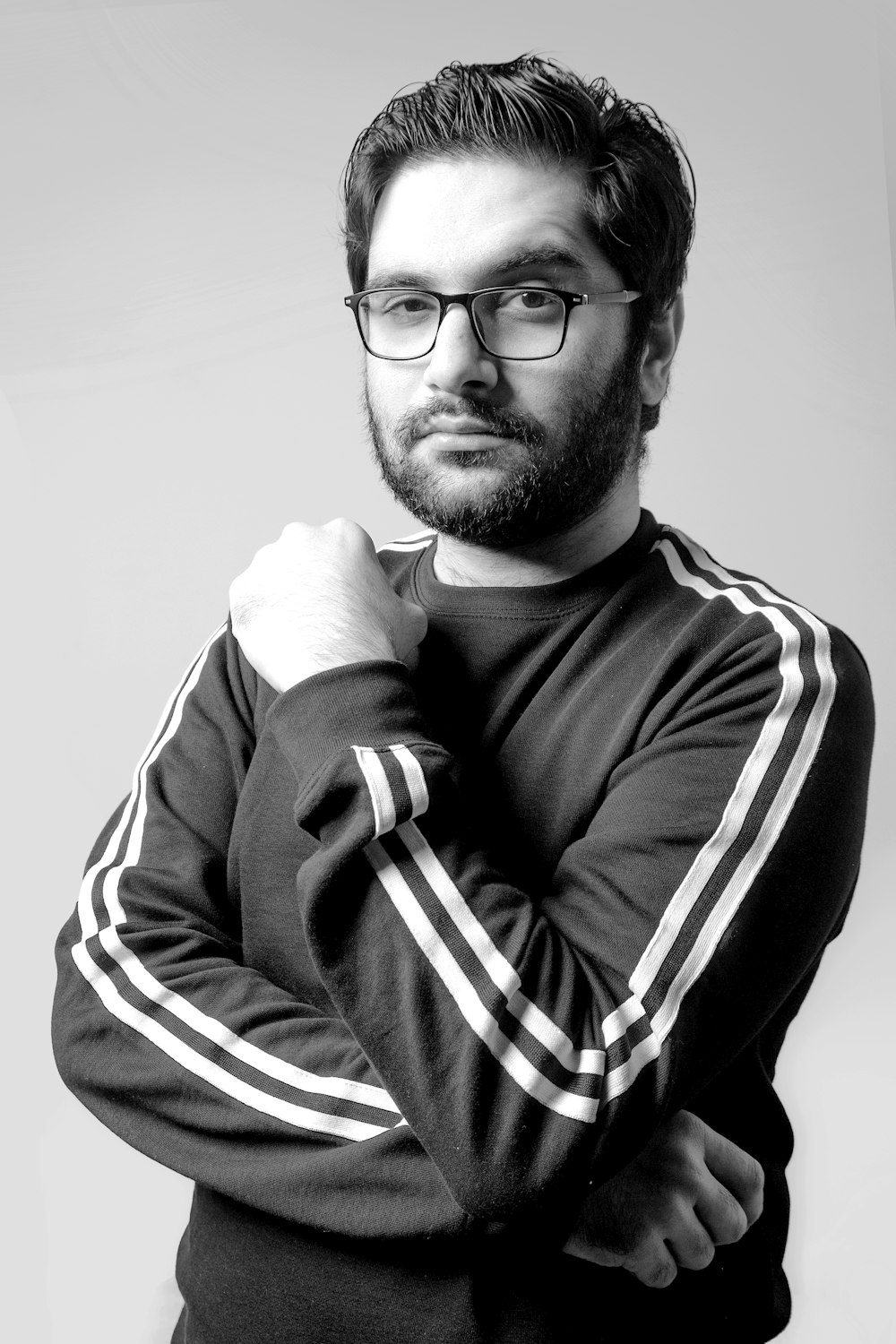 man in black and white striped long sleeve shirt wearing black framed eyeglasses