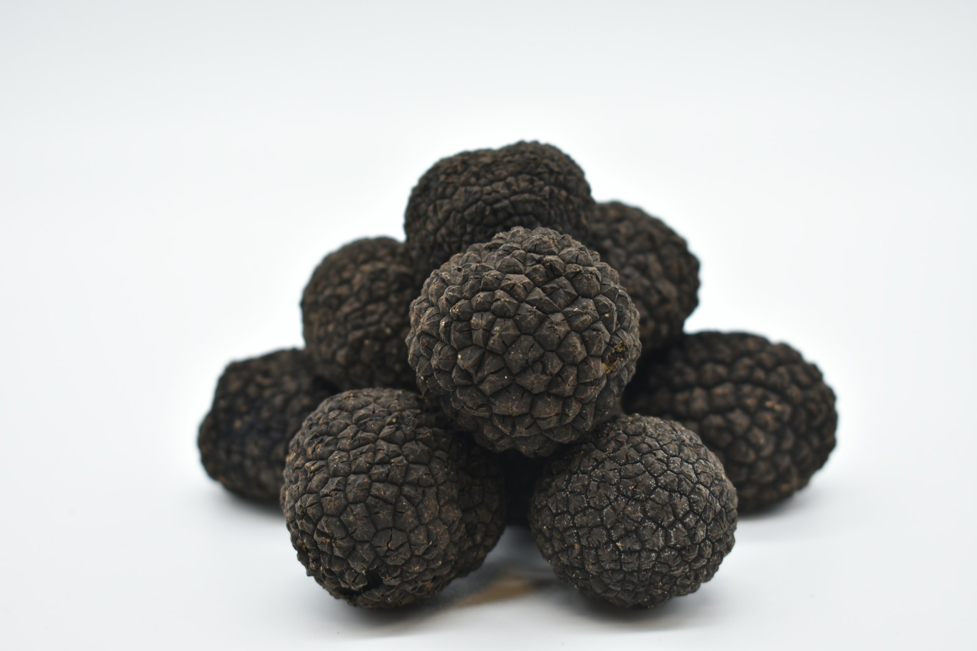 brown round fruit on white surface