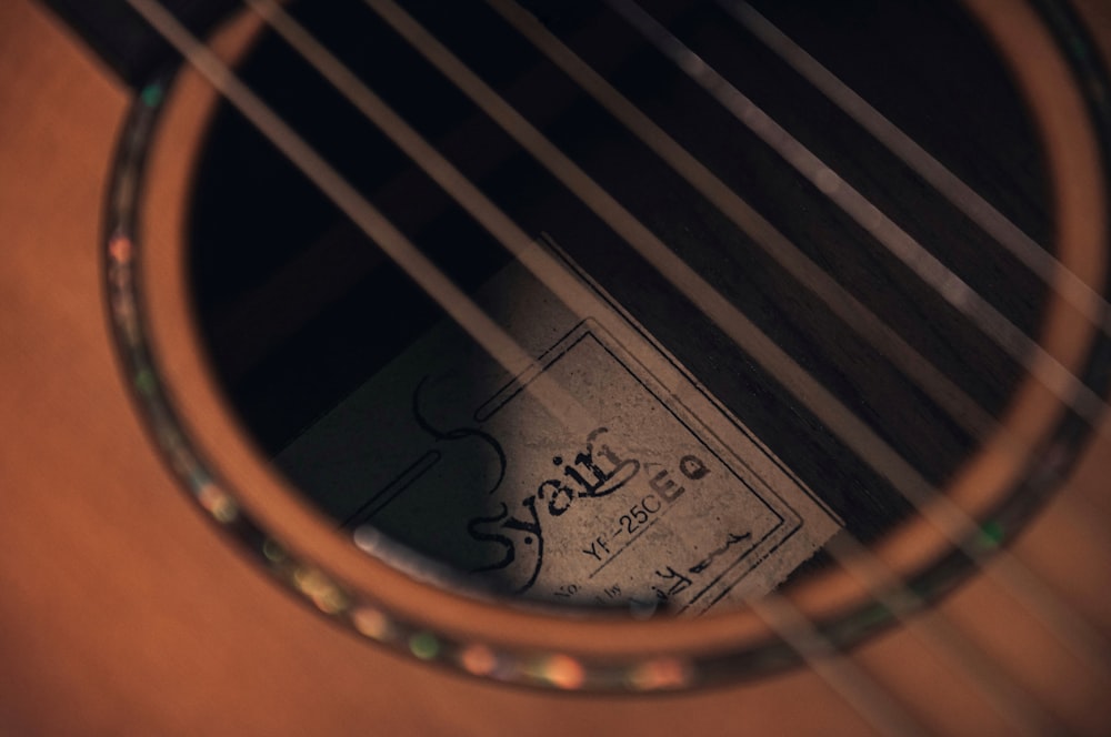brown acoustic guitar with black guitar print
