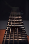 brown acoustic guitar in close up photography