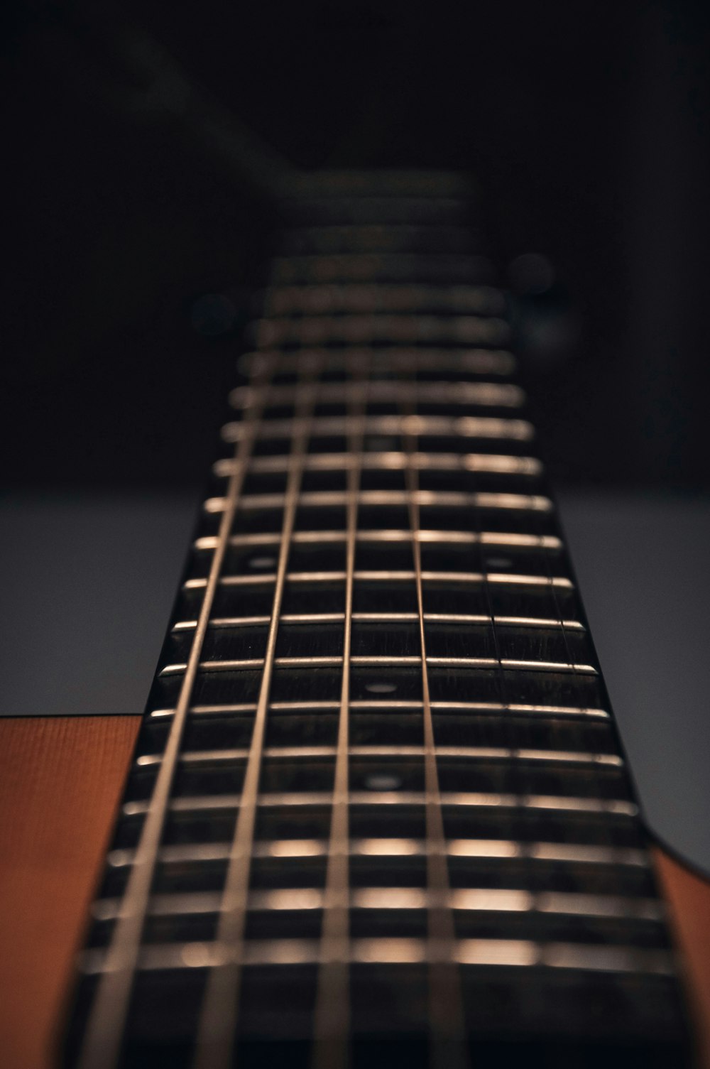 brown acoustic guitar in close up photography