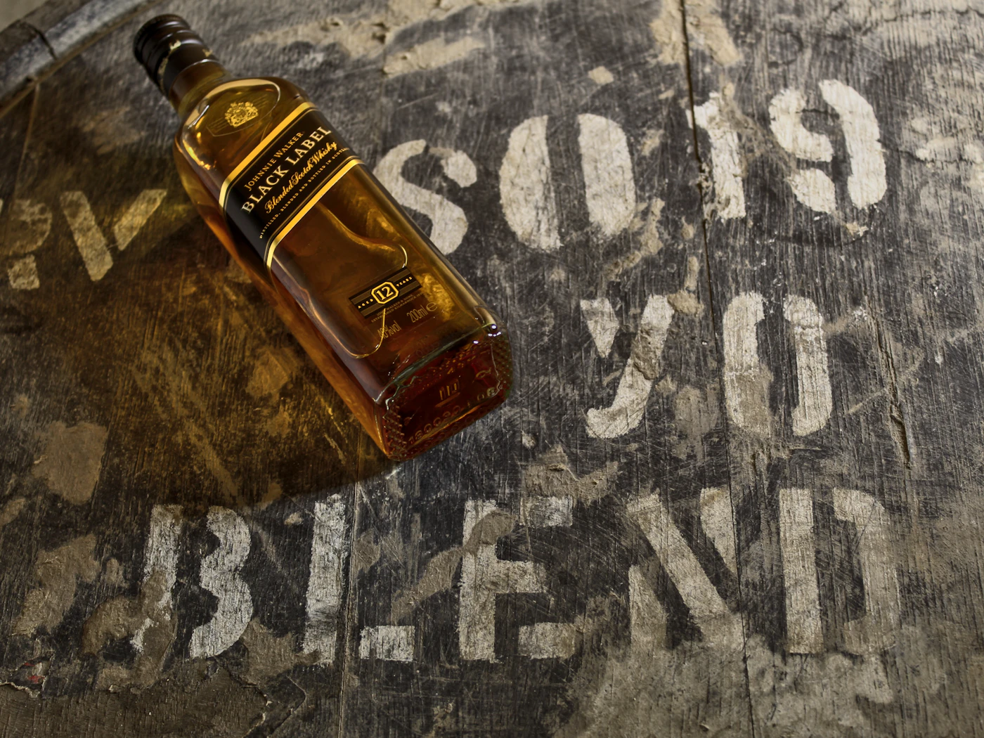 Glass of whisky beside the bottle