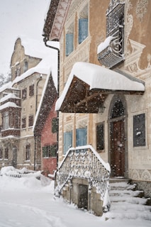 brown and white concrete building covered with snow