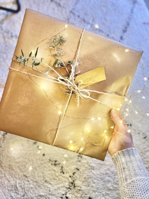 person holding brown gift box