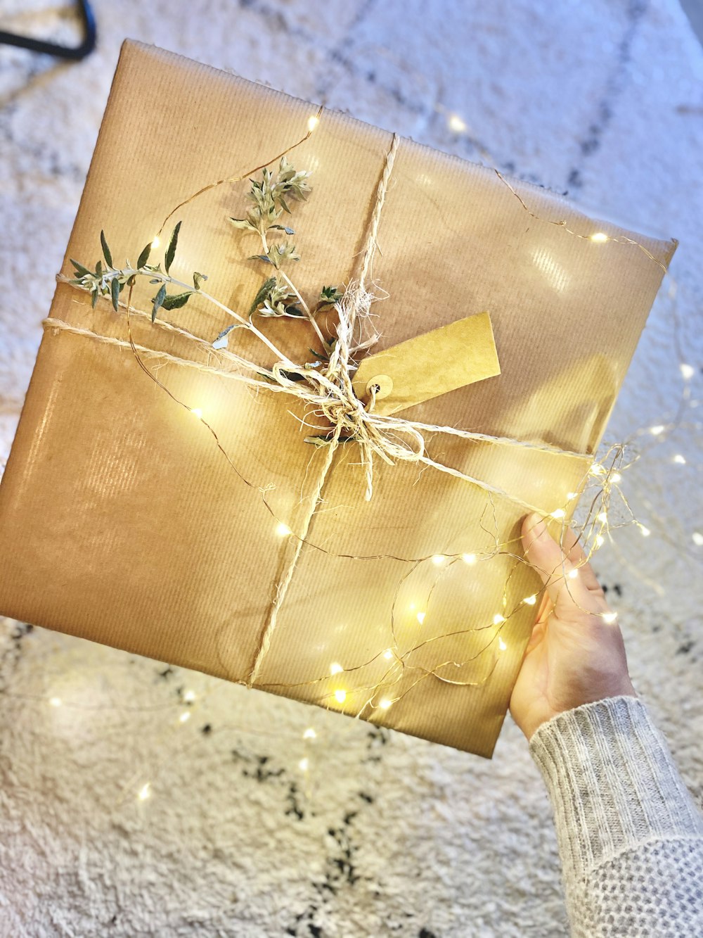 person holding brown gift box