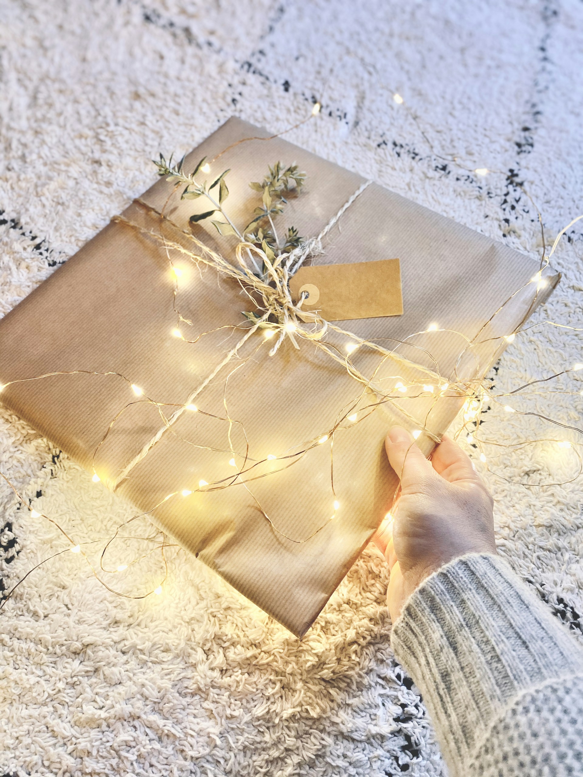 brown paper bag on white textile