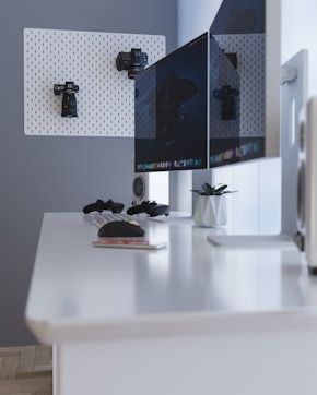 black flat screen computer monitor on white desk