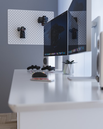 black flat screen computer monitor on white desk