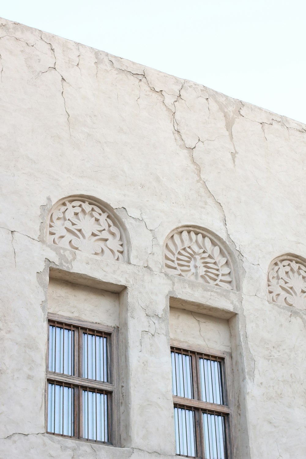 blue wooden window on white concrete wall