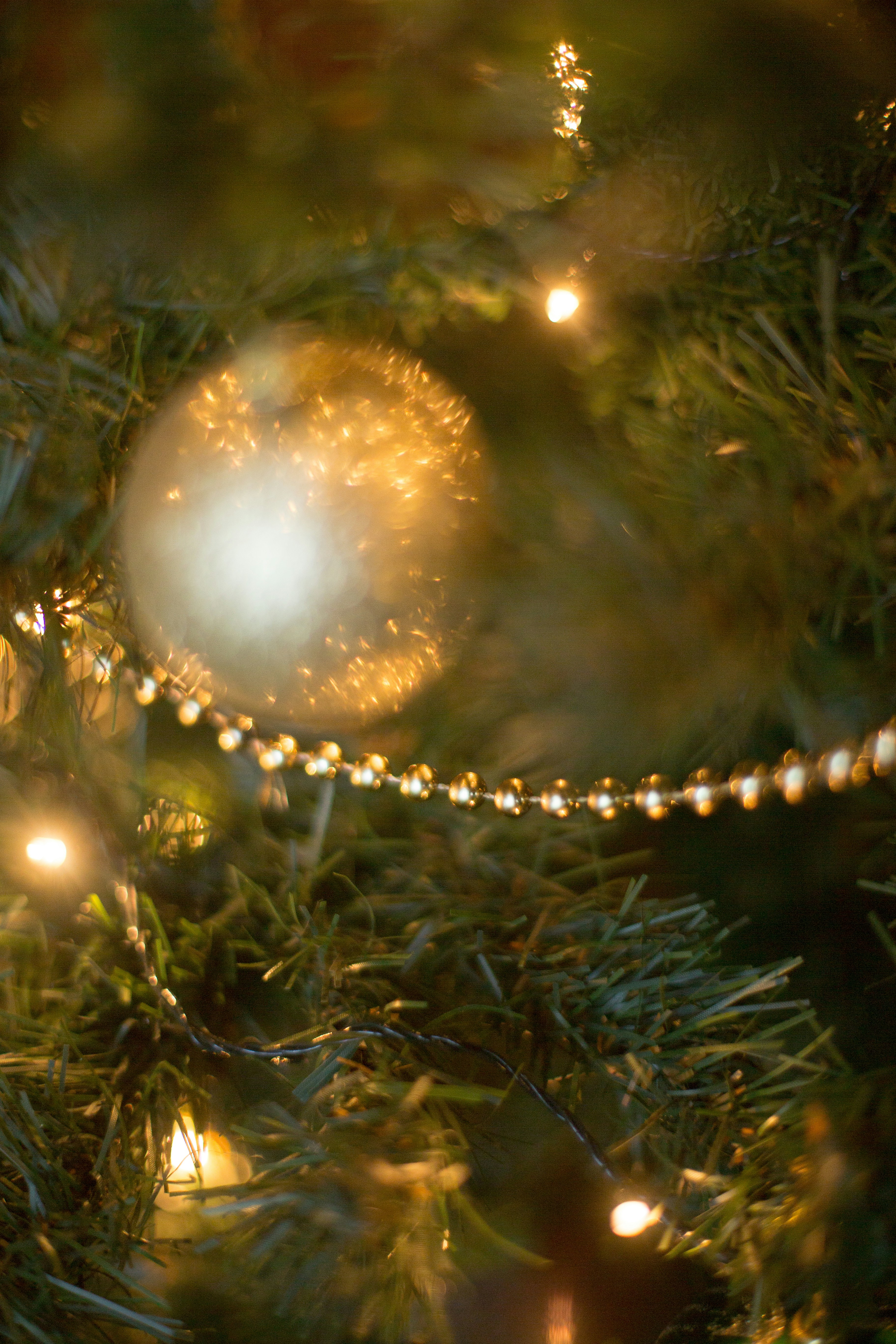 Close up of balls on Christmas tree. Bokeh garlands in the background. New Year concept.