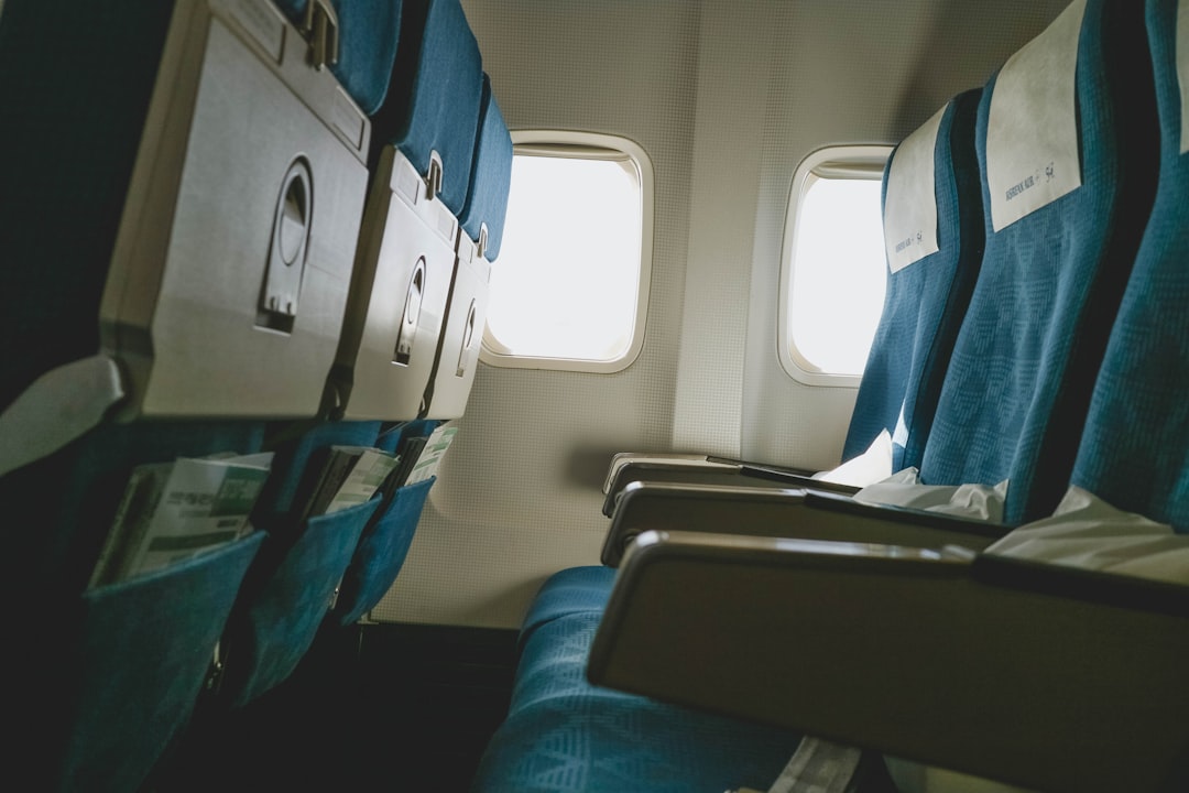 blue and white train seats, inside airplane