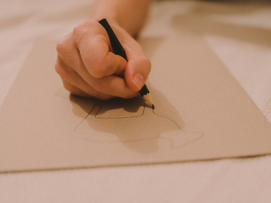 person writing on white paper,