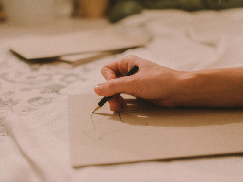 Hands sketching in a notebook