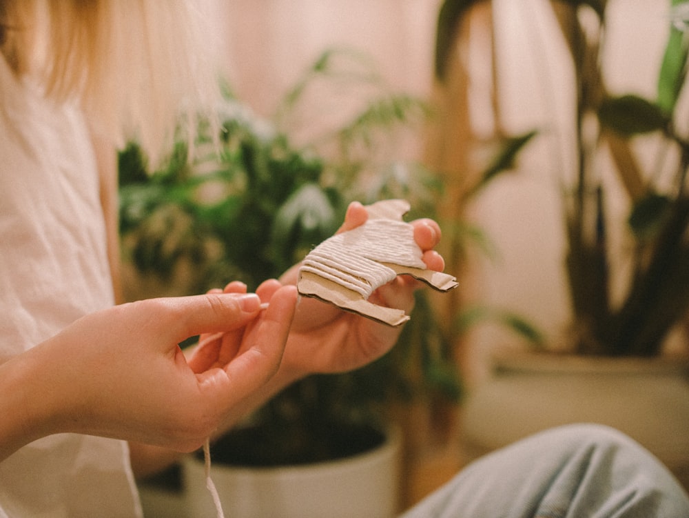 person holding white paper plane