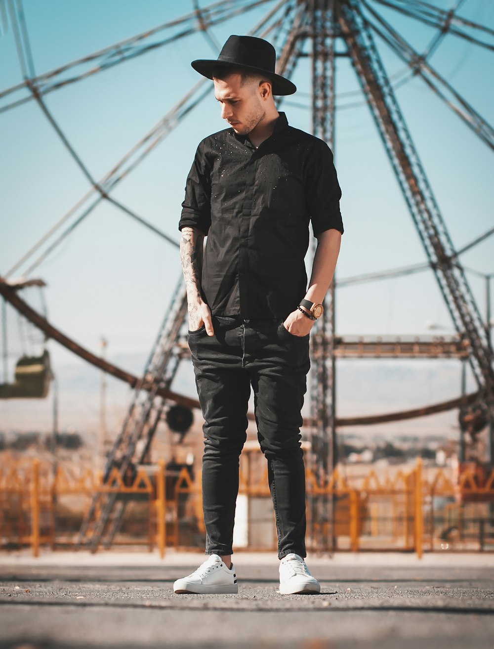 man in black button up shirt standing on bridge during daytime