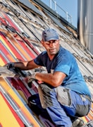 man in blue crew neck t-shirt cleaning solar panels