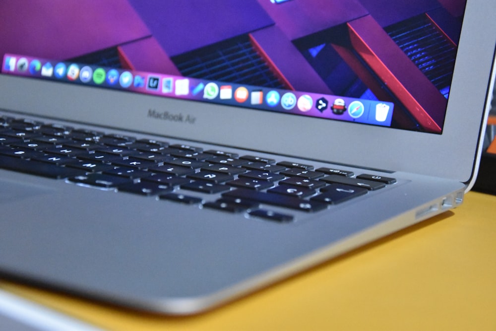 macbook air on brown wooden table