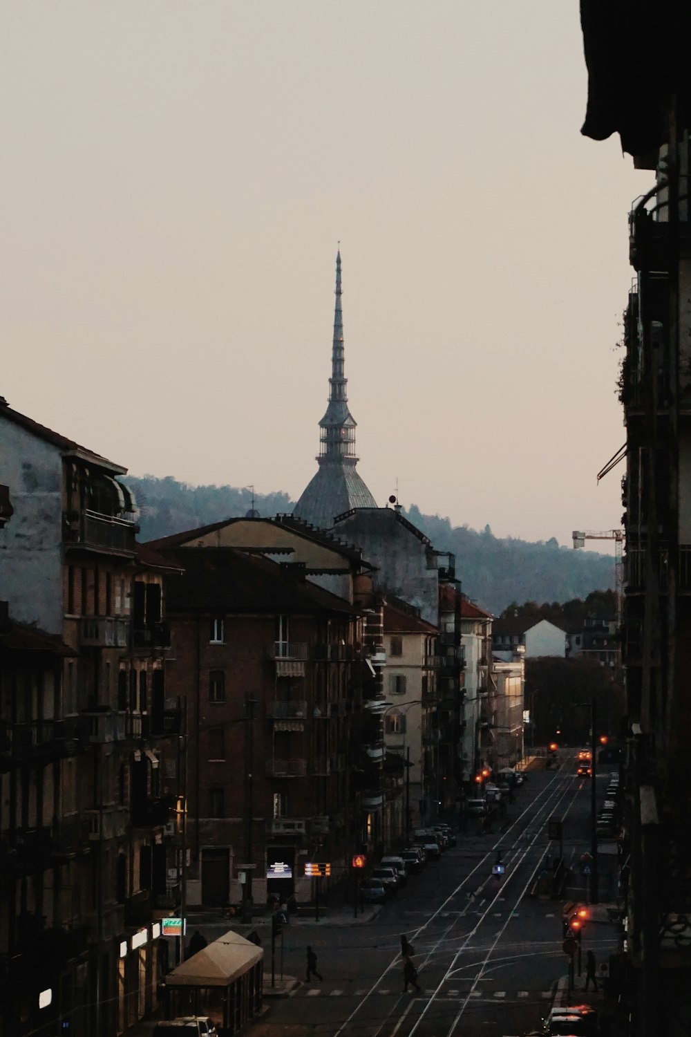 cars parked on street between buildings during daytime