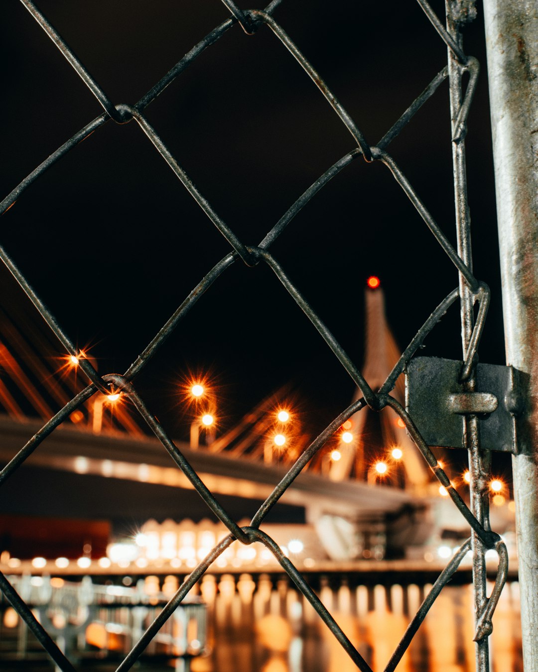 grey metal fence with lights during night time