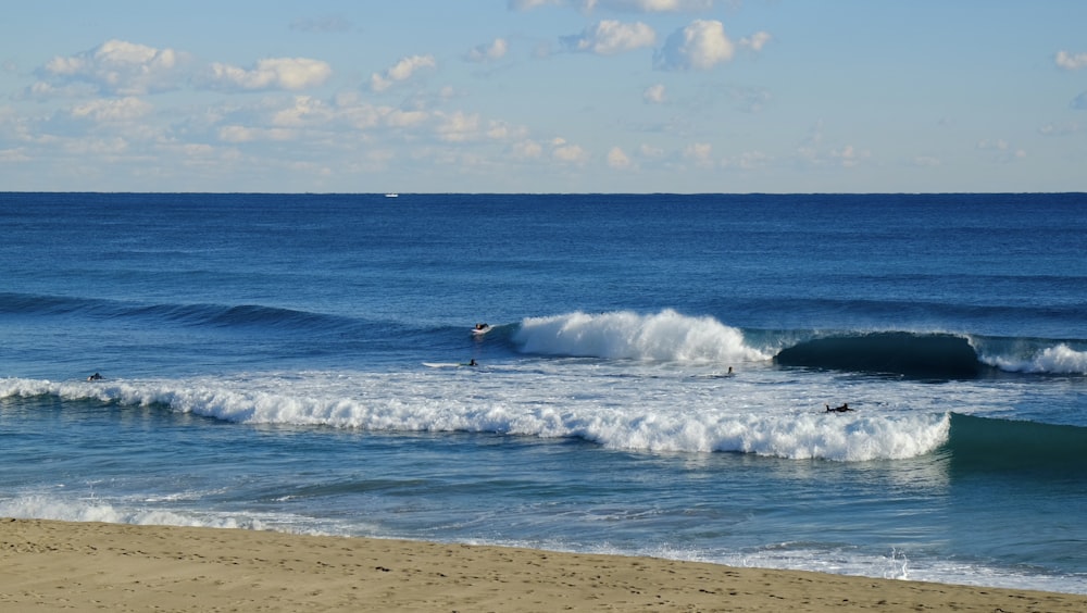 person surfing on sea waves during daytime