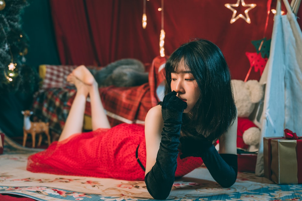 woman in red long sleeve shirt sitting on floor