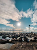 Wide shot of a South Sound marina with a technician inspecting a boat's electrical system on a sunny day.