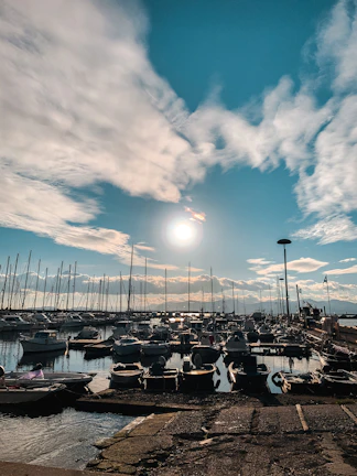 Wide shot of a South Sound marina with a technician inspecting a boat's electrical system on a sunny day.
