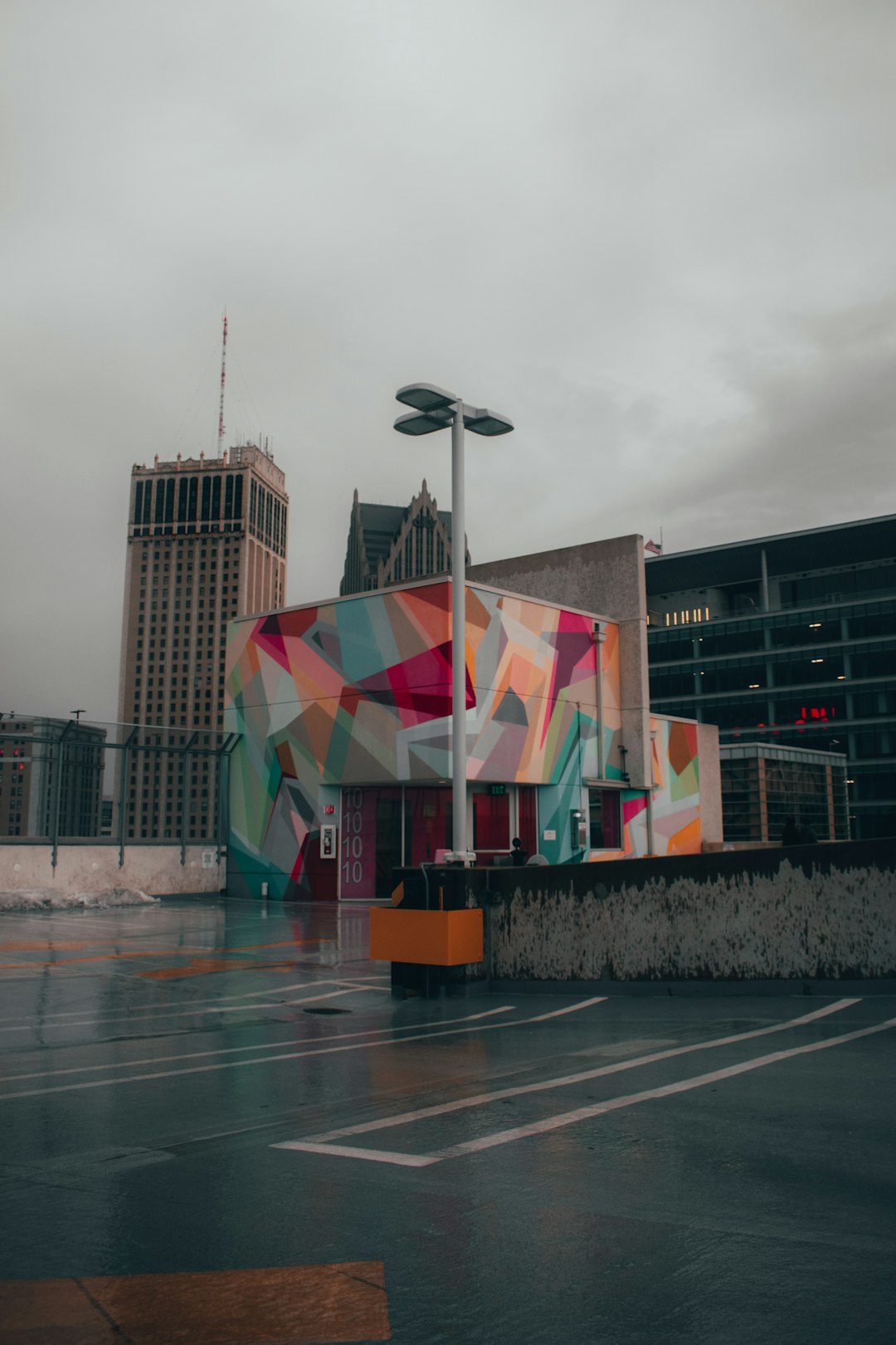 multi color flags on gray concrete floor near brown concrete building during daytime