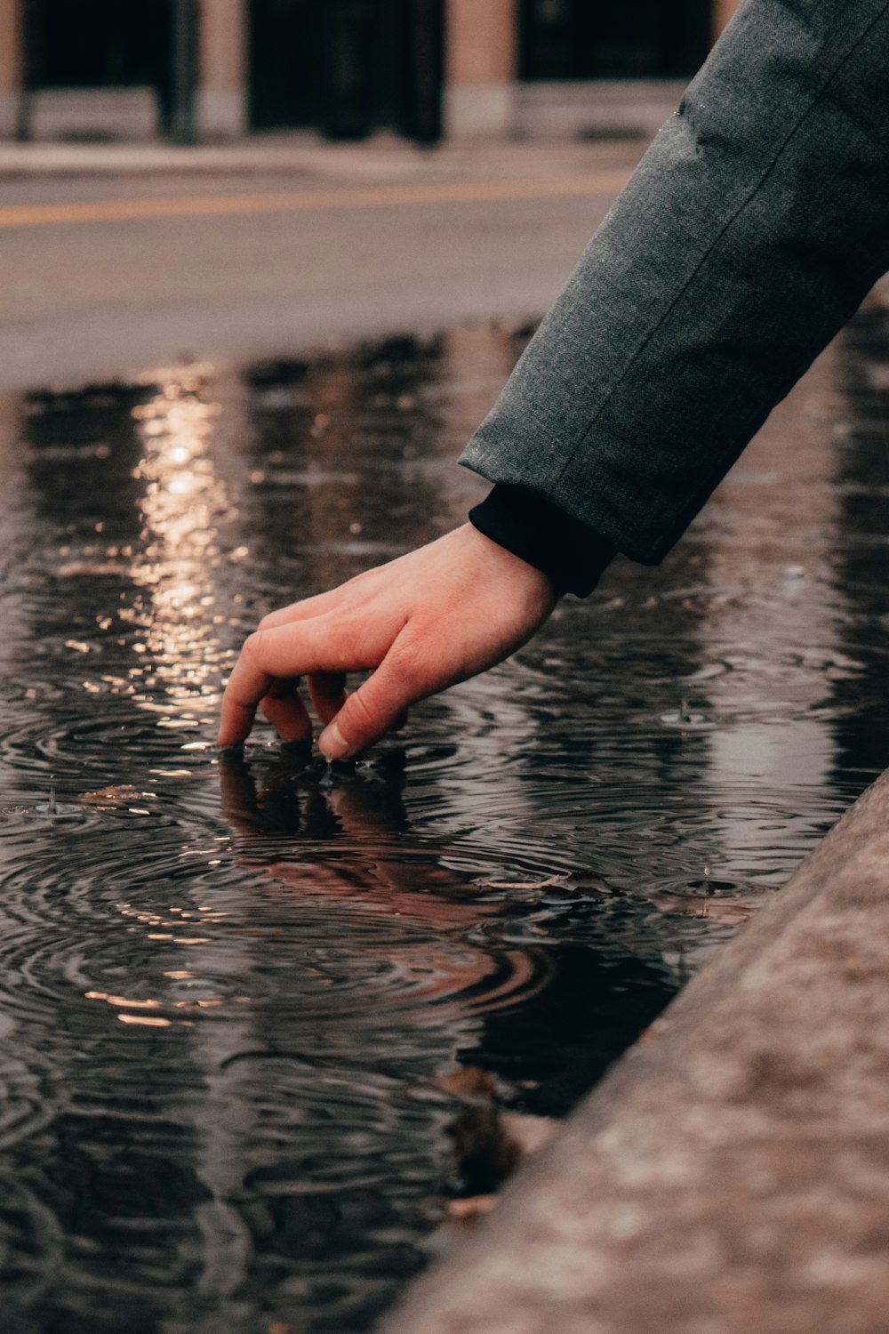 person in gray long sleeve shirt holding water