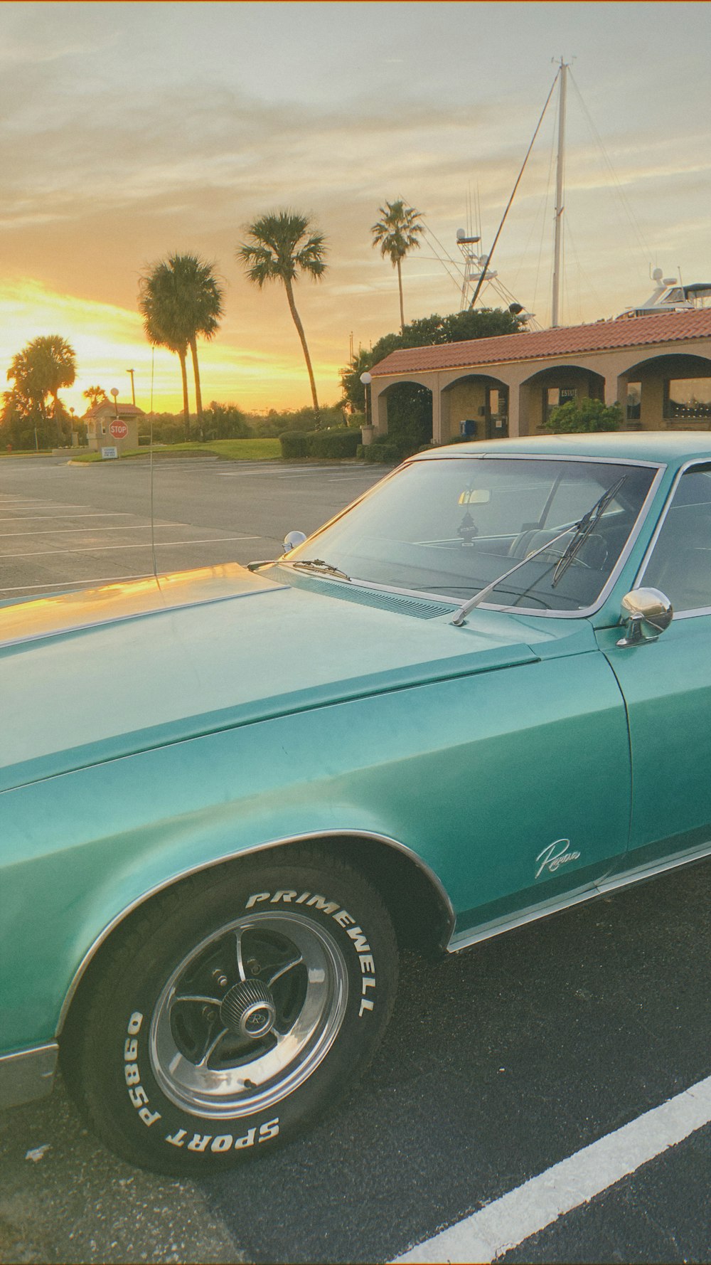 teal car parked on the side of the road