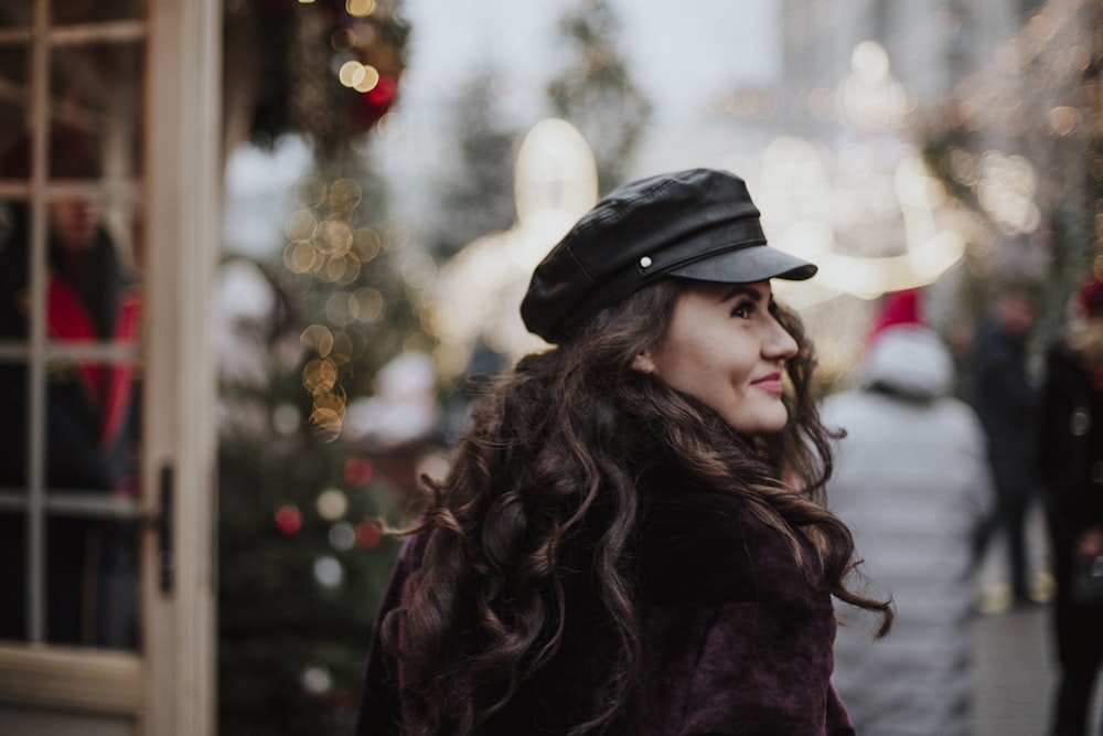 woman in black hat and brown coat