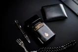 A sleek, dark-mode styled flat lay featuring the perfume bottle, a gold-accented box, and a handwritten note in Arabic calligraphy.