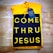 A folded yellow hoodie with a design reading 'COME THRU JESUS' in large, bold yellow letters on a black background. A blue tag attached to the hoodie reads 'FRESH HOPE APPAREL'. The hoodie is placed on a wooden surface.