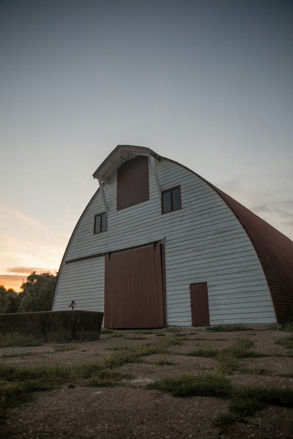 brown wooden barn house on green grass field during daytime