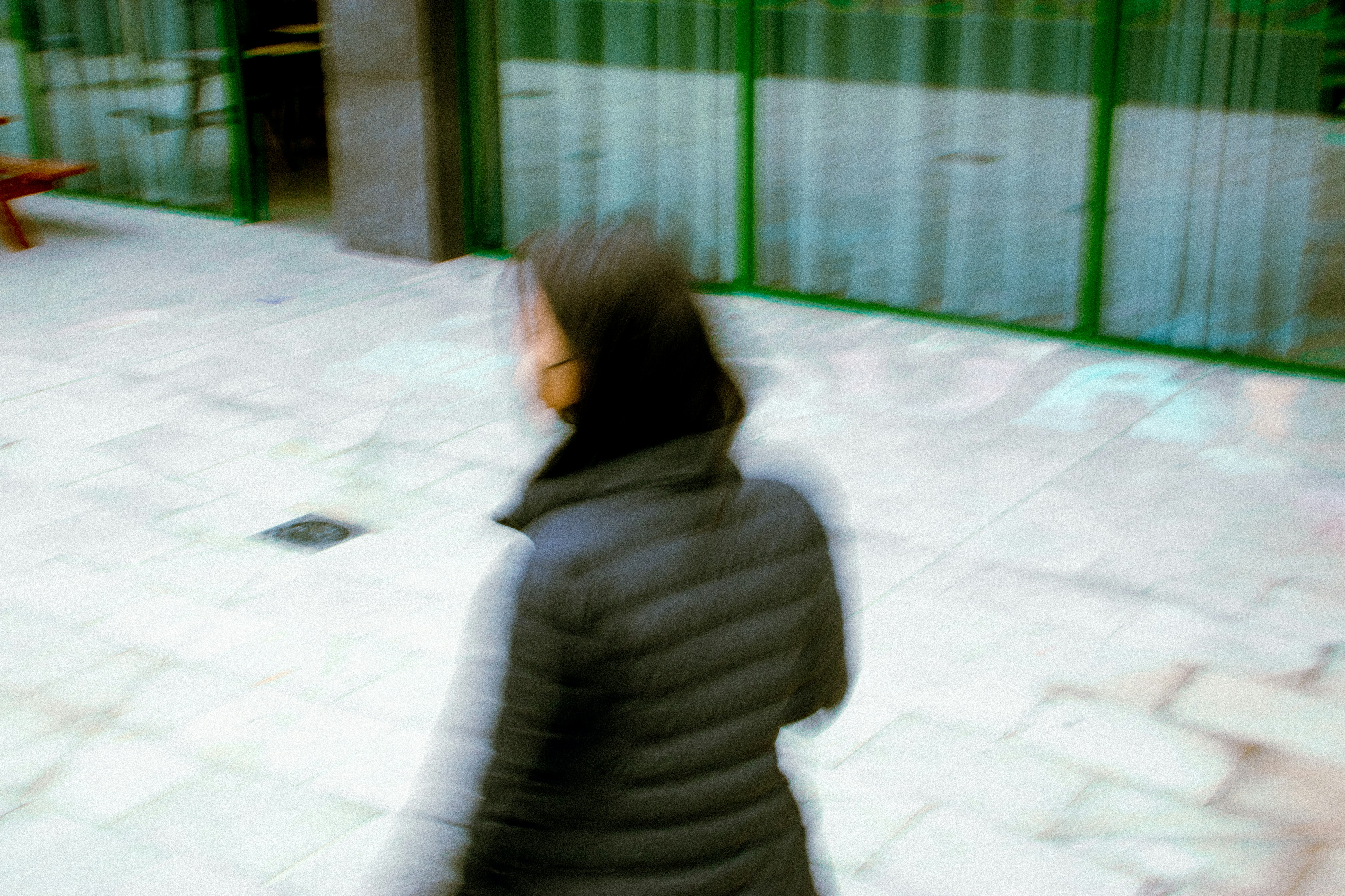 woman in gray hoodie sitting on white floor tiles