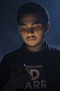 A person looking at their phone with a concerned expression.