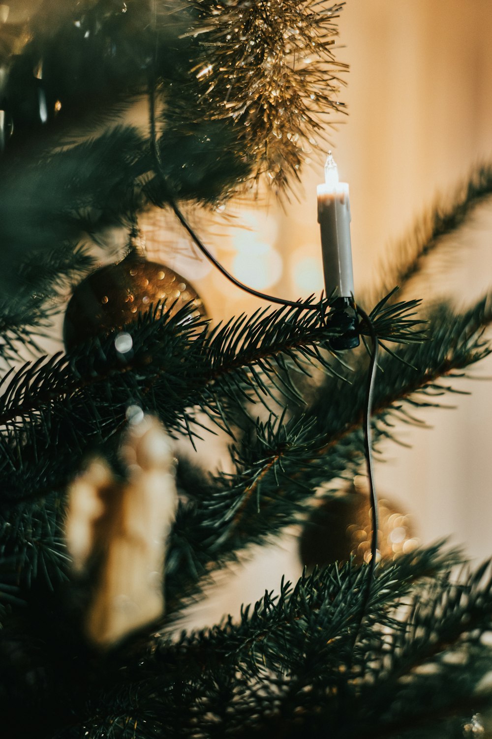 white candle on green christmas tree