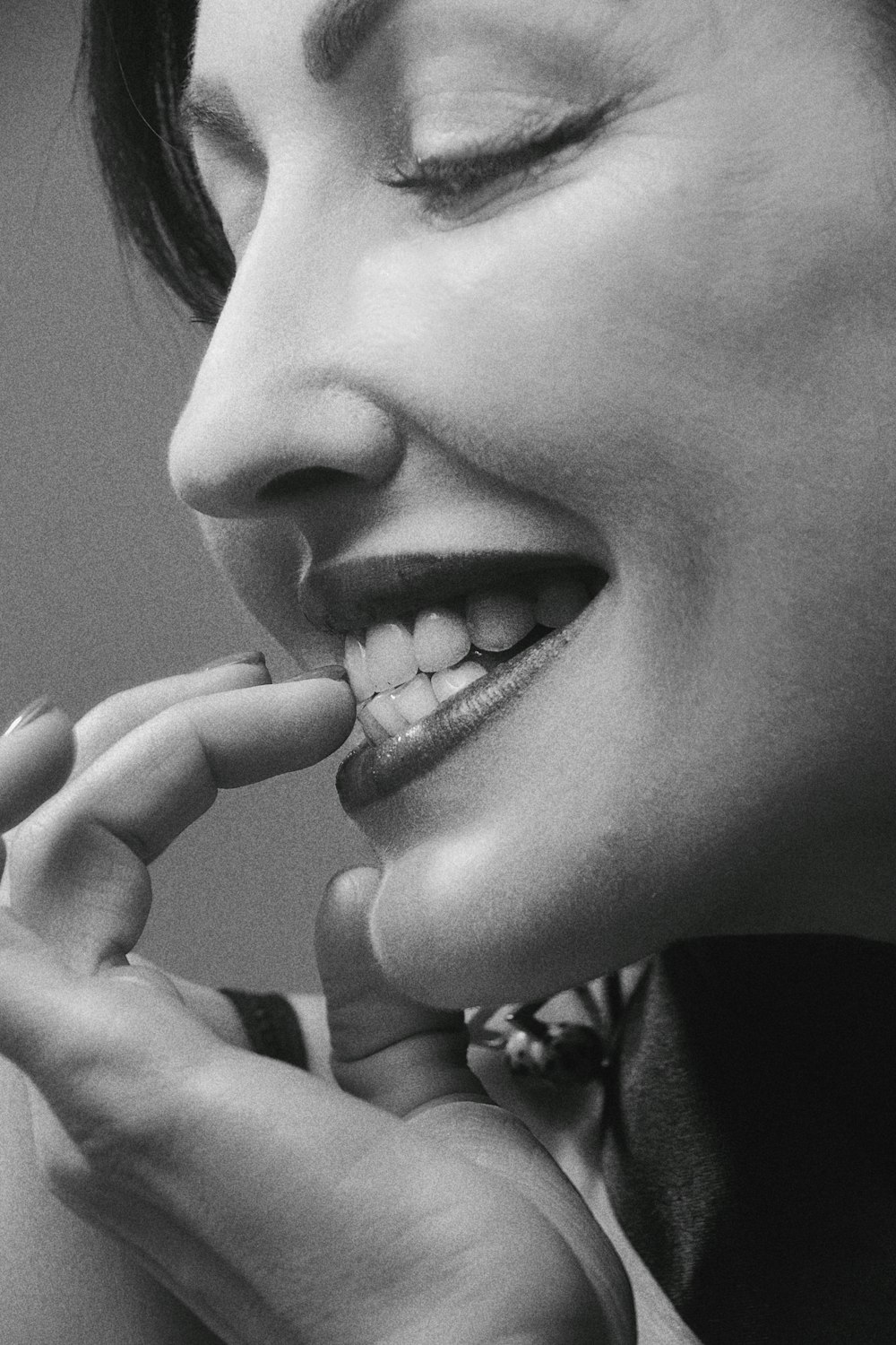 grayscale photo of woman with hand on her chin