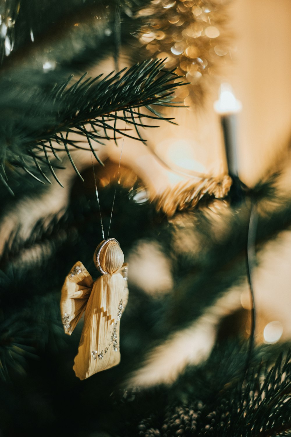 angel figurine on green pine tree